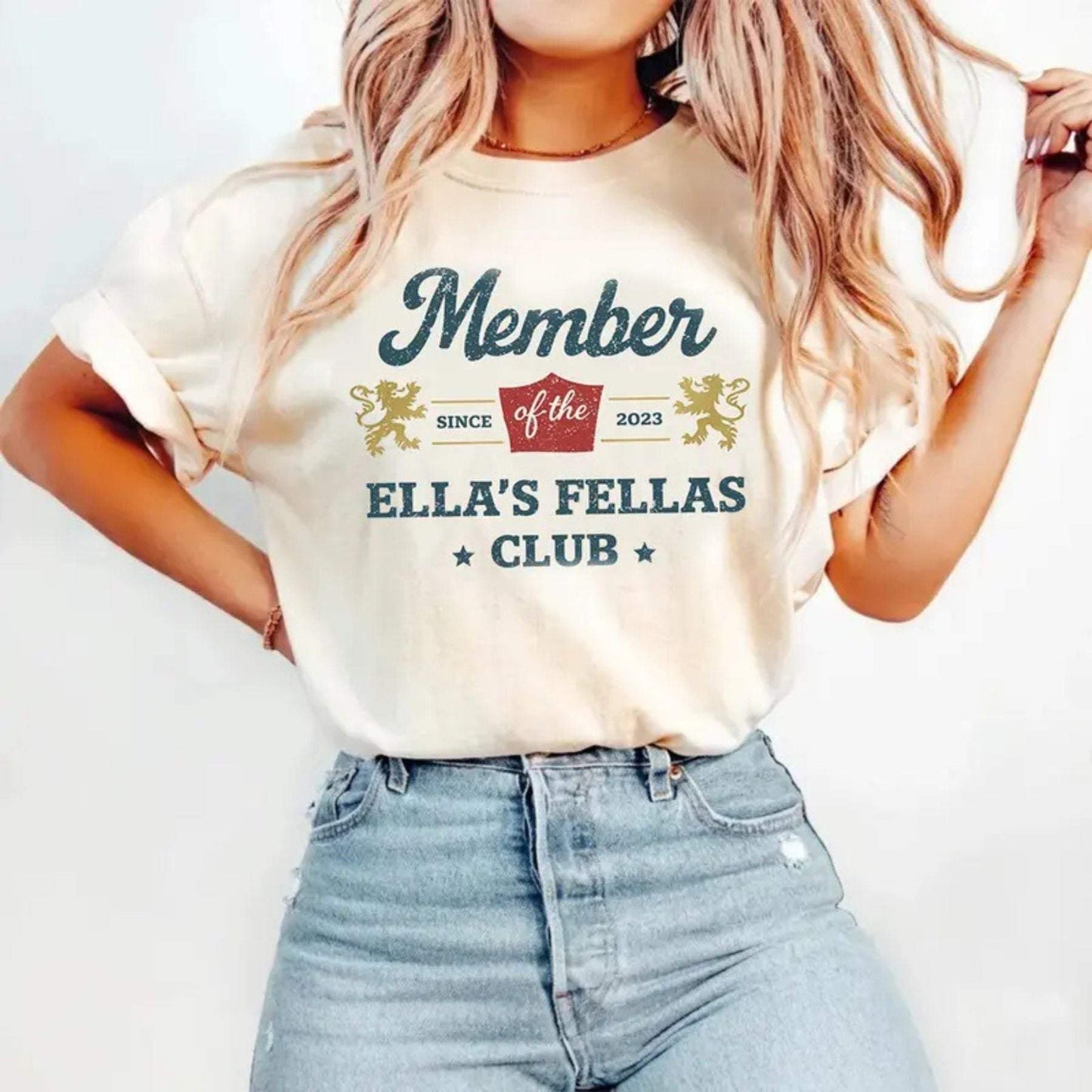 Ellas Fellas Club western t-shirt in cream cotton with distressed vintage graphic, bold lettering and rodeo emblems