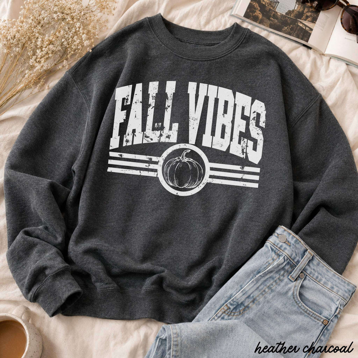 Fall Vibes Sweatshirt in heather charcoal with a white distressed graphic, pumpkin emblem, and stripe details