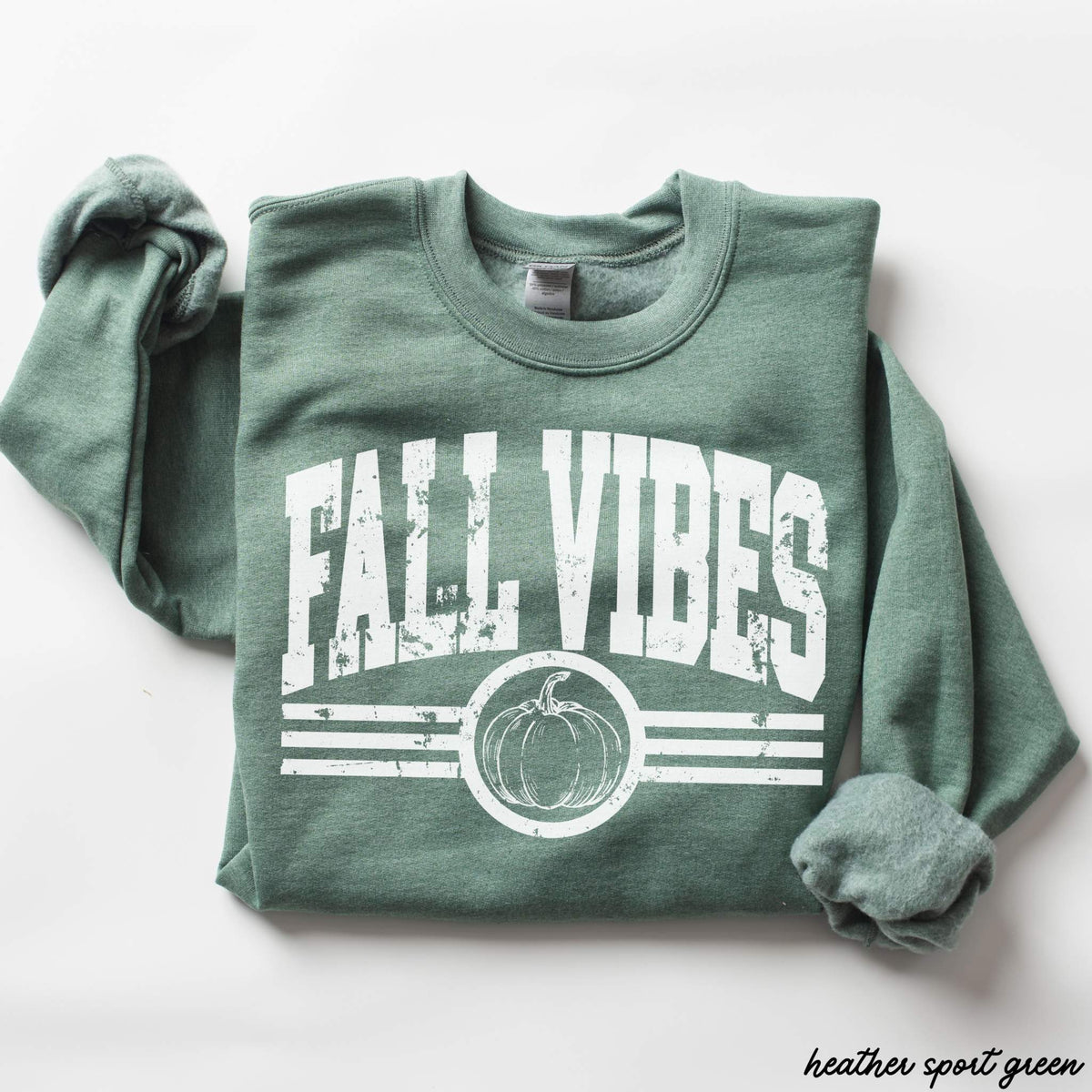 Fall Vibes Sweatshirt in heather sport green with distressed white lettering, pumpkin graphic, and stripe details