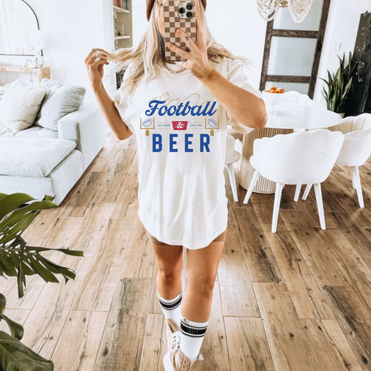 Football & Beer T Shirt in white cotton with blue lettering, football graphics, and a collegiate-style printed design