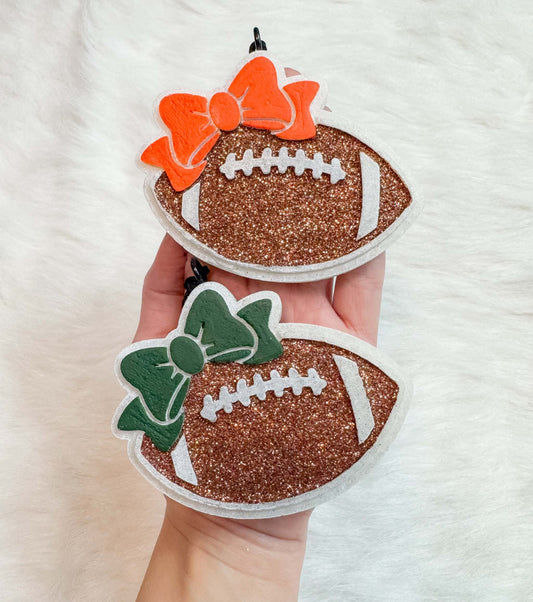Football Freshie glitter football-shaped air fresheners with orange and green bows and white laces