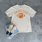 Football Graphic Tee in ivory cotton with distressed orange Game Day lettering and football graphic