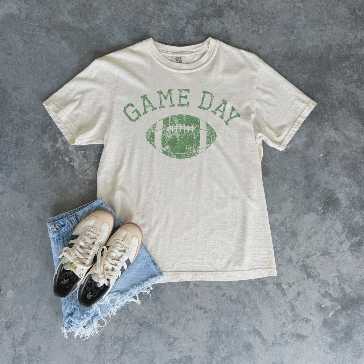 Football Graphic Tee in ivory cotton with green distressed Game Day lettering and football graphic
