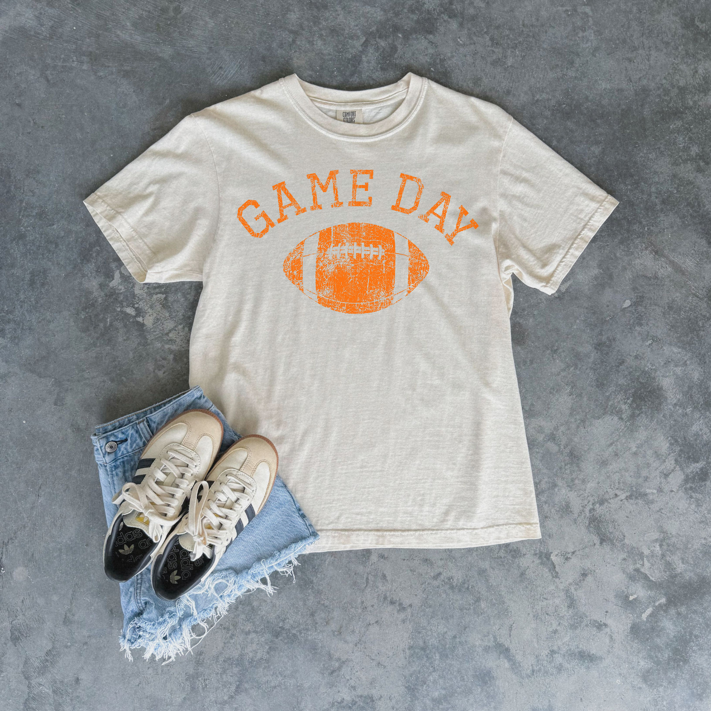 Football Graphic Tee in ivory cotton with orange distressed Game Day lettering and football graphic