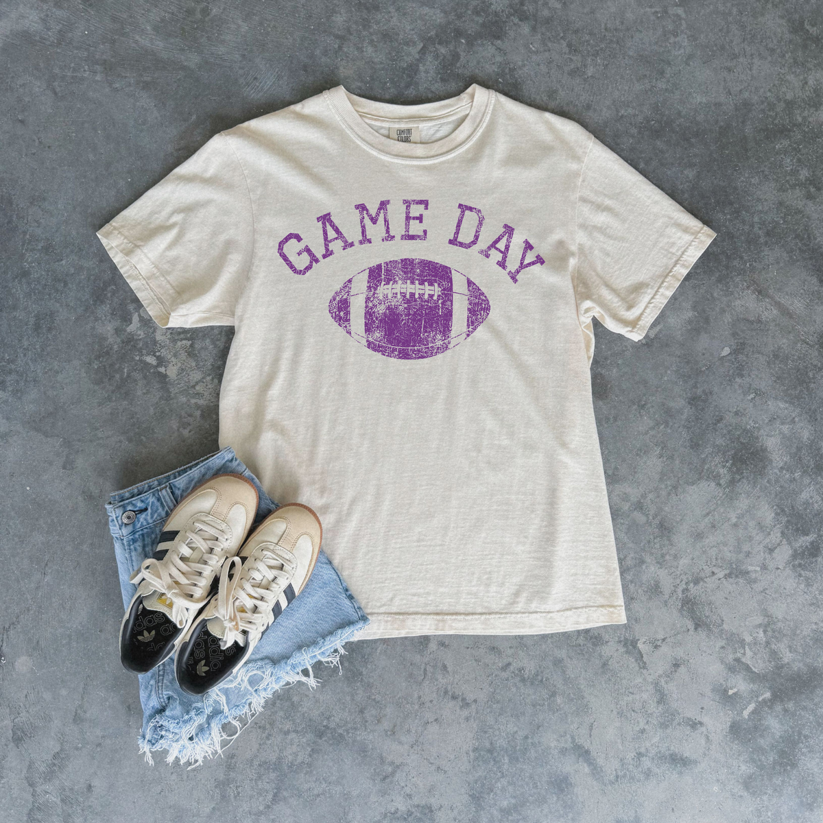 Football Graphic Tee in ivory cotton with distressed purple Game Day lettering and football graphic