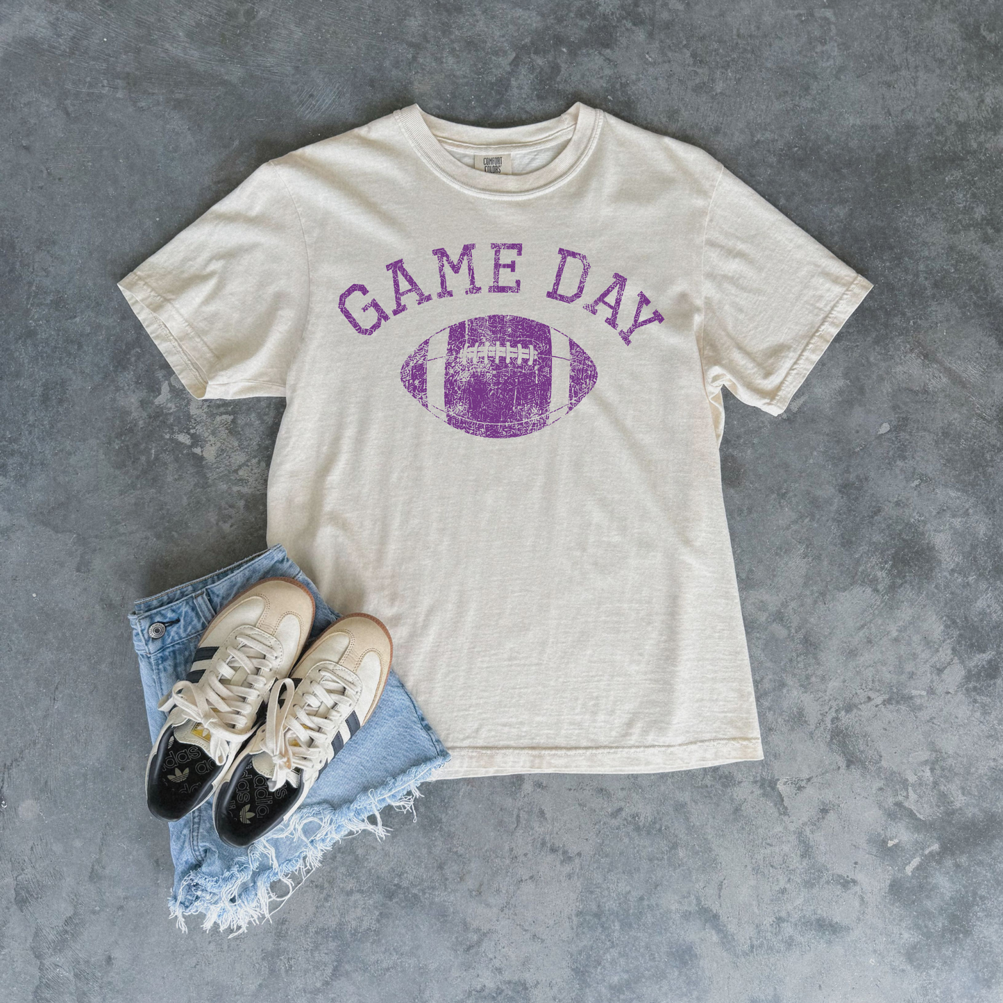 Football Graphic Tee in ivory cotton with distressed purple Game Day lettering and football graphic