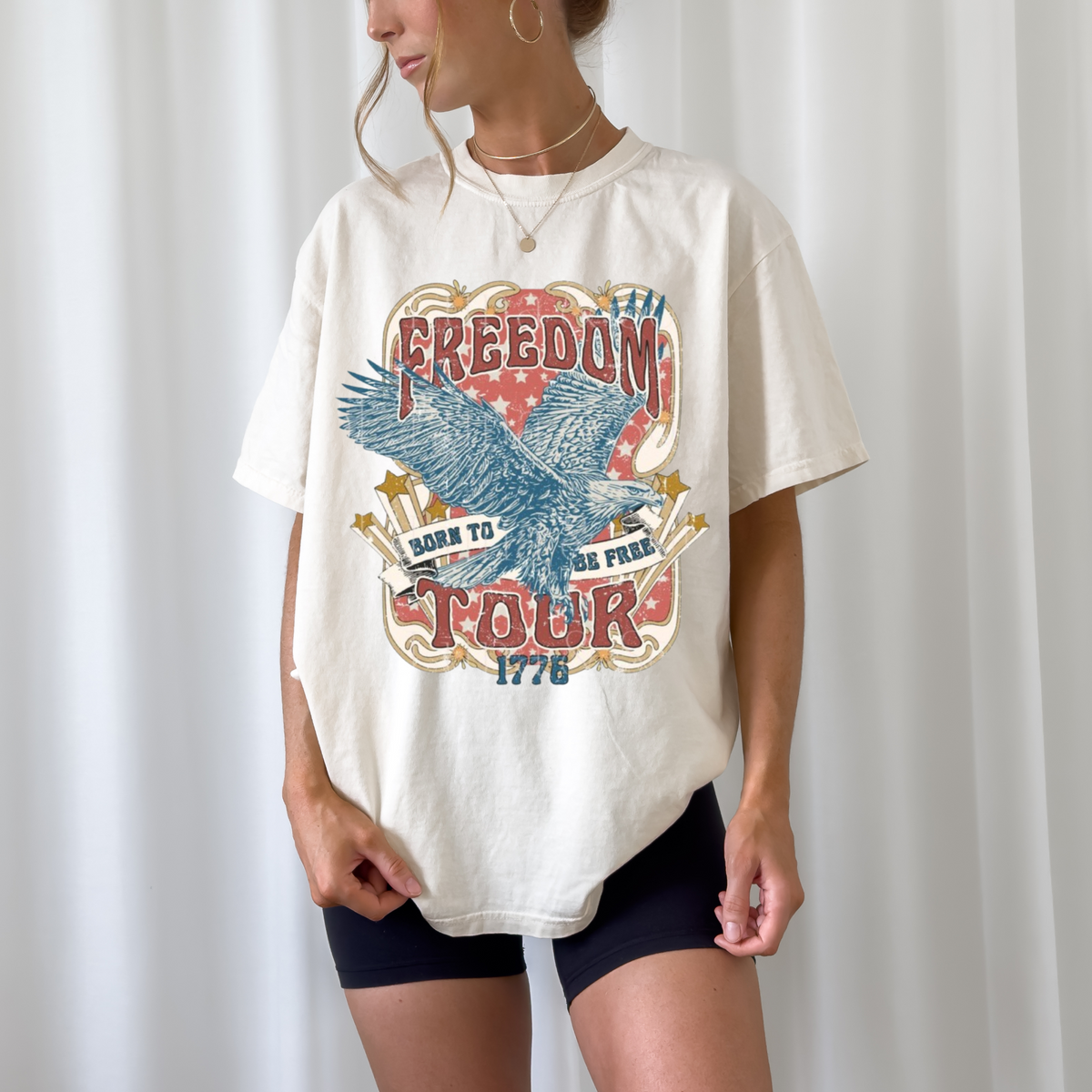 Freedom Tour Tee in off-white cotton featuring a vintage-style patriotic graphic with an eagle, stars, and bold text