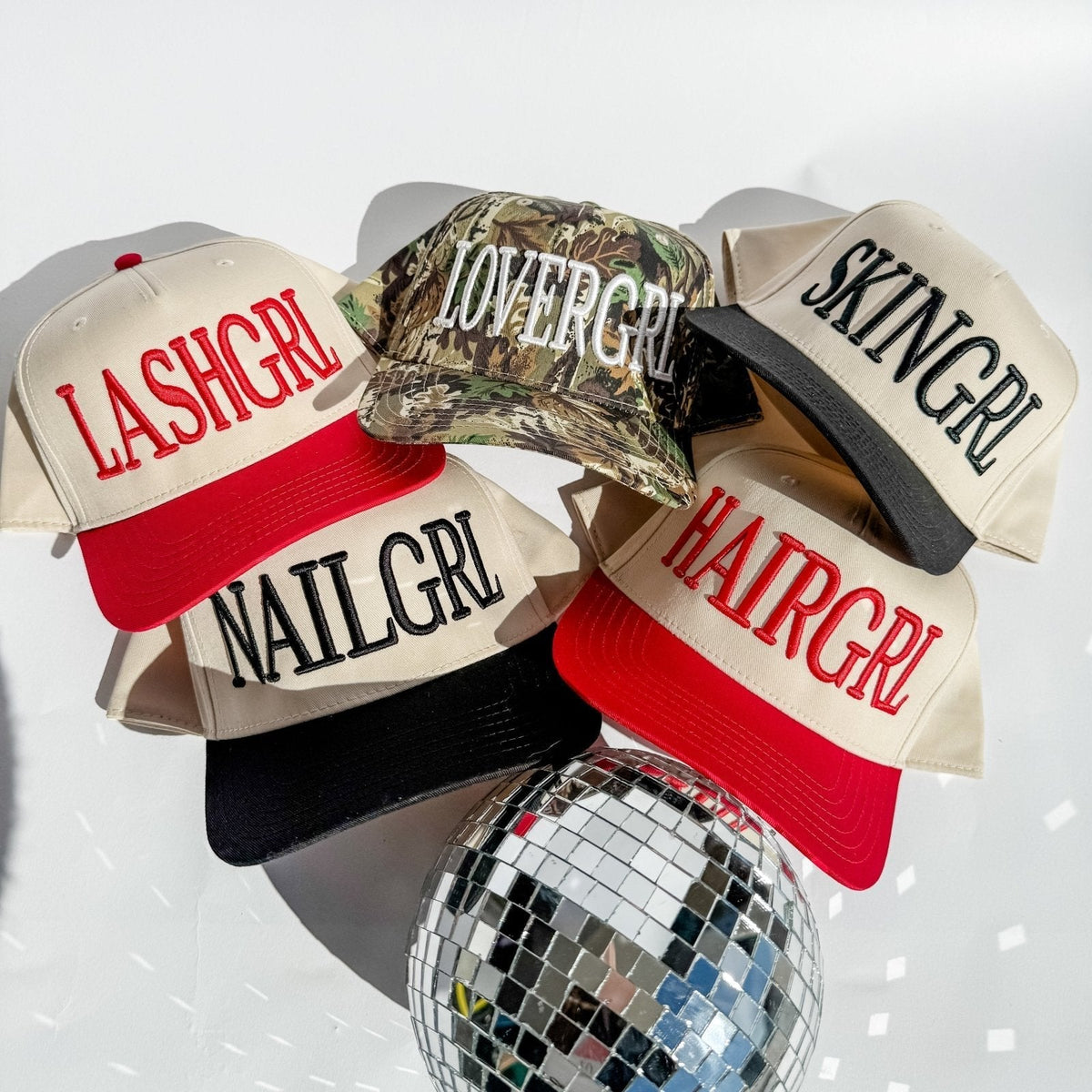 HAIRGRL - Trucker Hat in cream with a red bill featuring bold raised red puff embroidery and adjustable snapback closure