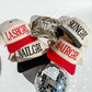HAIRGRL - Trucker Hat in cream with a red bill featuring bold raised red puff embroidery and adjustable snapback closure