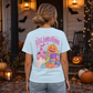 Halloweentown Graphic T-Shirt in light blue cotton with colorful haunted town, pumpkins, ghosts, and jack-o'-lantern graphic