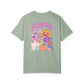 Halloweentown Graphic T-Shirt in sage green cotton with colourful haunted house, pumpkins, ghosts and jack-o'-lantern graphic