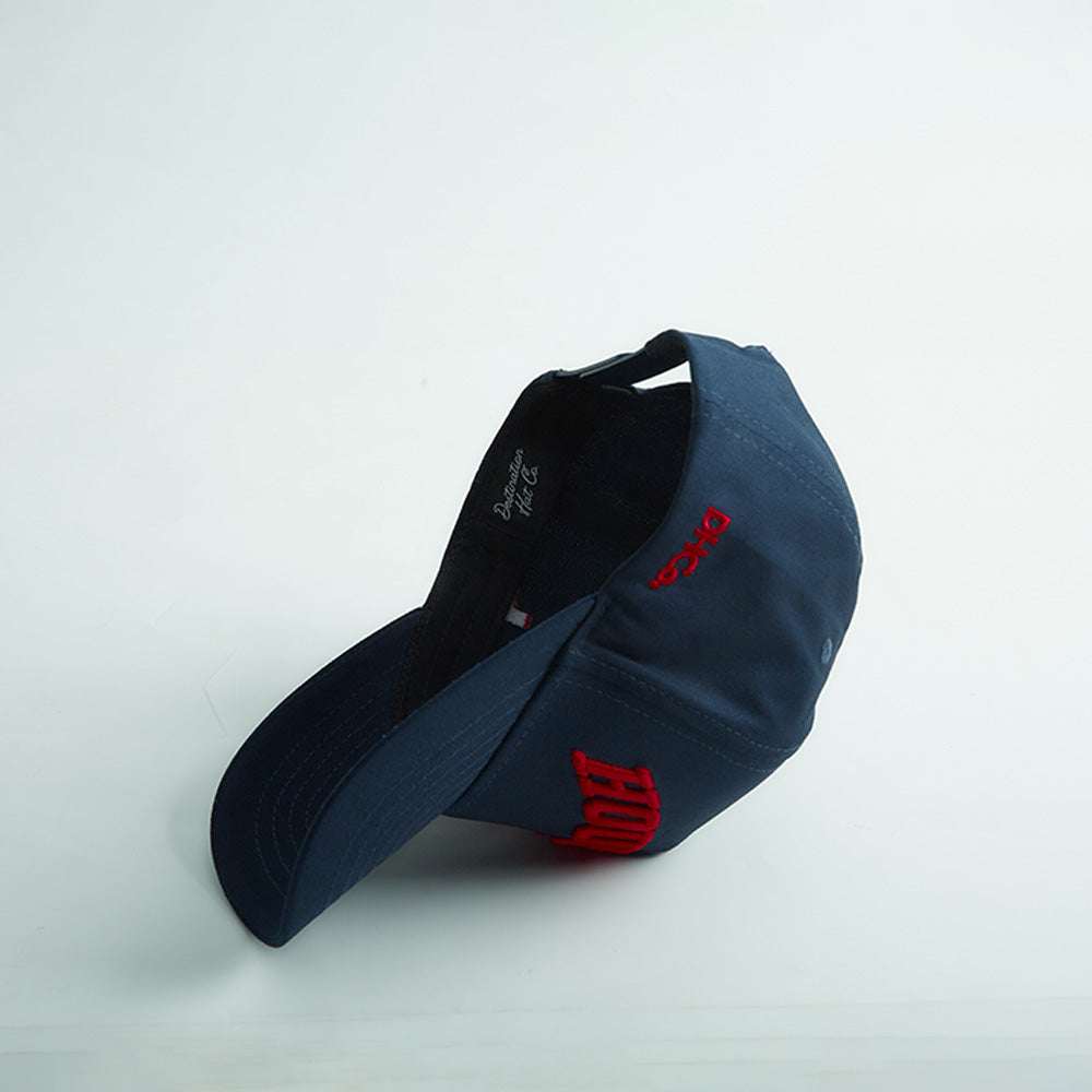 Houston Legacy Snapback in dark navy cotton with red embroidered lettering, curved bill, and adjustable back