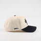 Houston Script Hat in beige cotton with black brim, embroidered script lettering, and curved baseball cap design