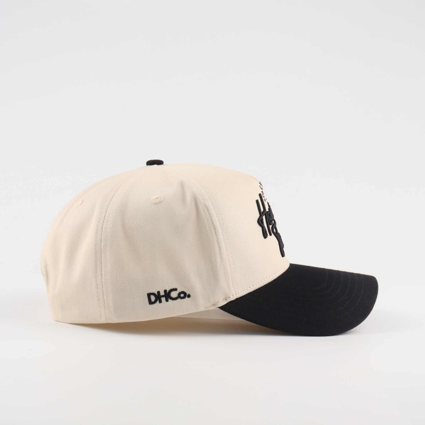 Houston Script Hat in beige cotton with black brim, embroidered script lettering, and curved baseball cap design