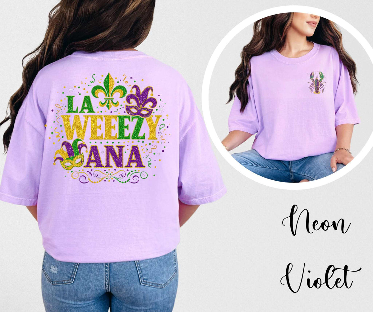 Purple t-shirt with colorful text and graphics, worn by a person, on a plain background.