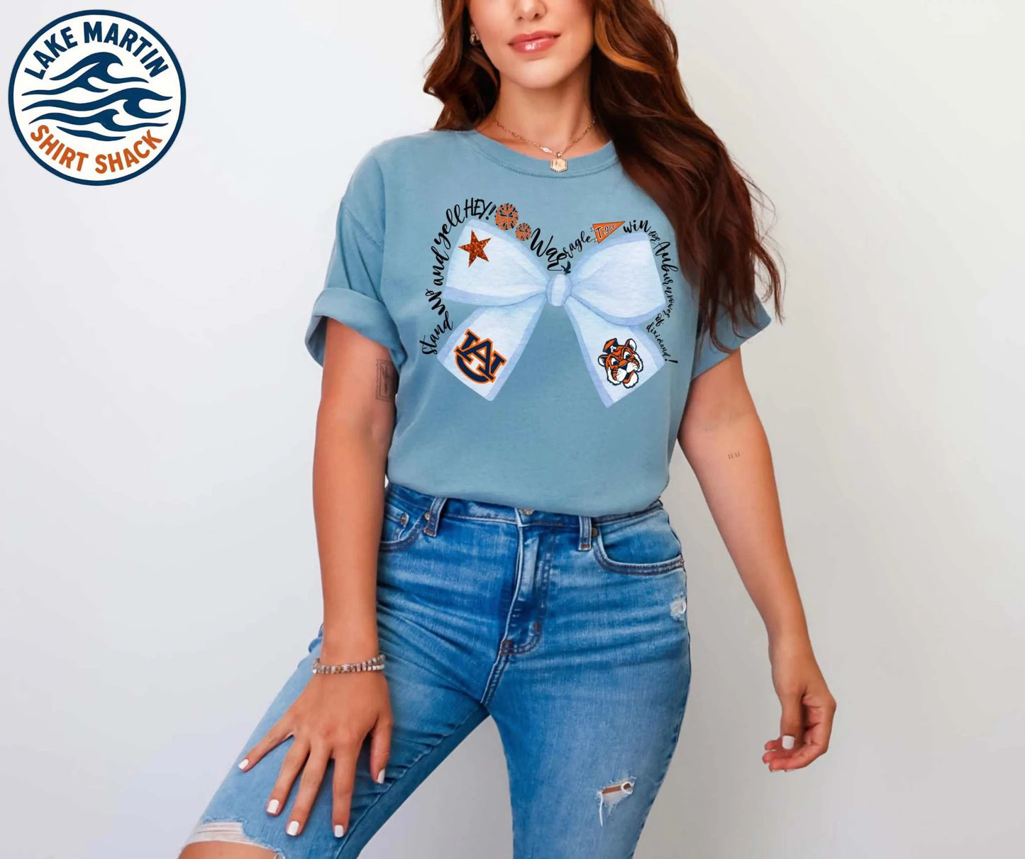 Blue and orange watercolor game-day bow on an Ice Blue Comfort Colors T-shirt