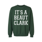 It's a Beaut Clark Christmas Sweatshirt in forest green fleece with bold white collegiate lettering and ribbed cuffs