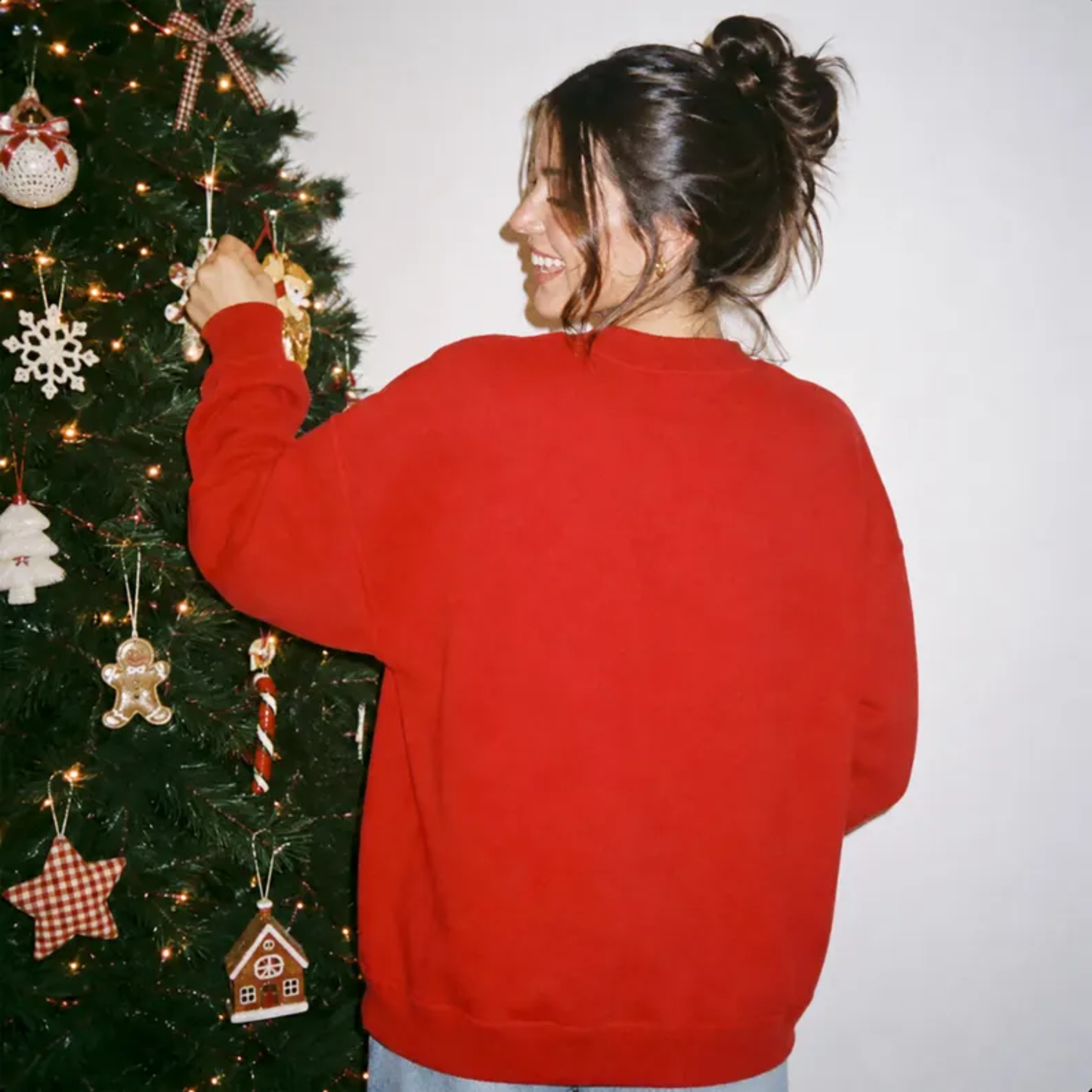 It's a Beaut Clark Christmas Sweatshirt in red with a soft fleece crewneck and relaxed unisex fit