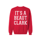It's a Beaut Clark Christmas Sweatshirt in red fleece with bold white collegiate lettering and ribbed cuffs