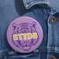 Round purple enamel pin button with a bold tiger head design and STTDB lettering, representing LSU Geaux Tiger pride