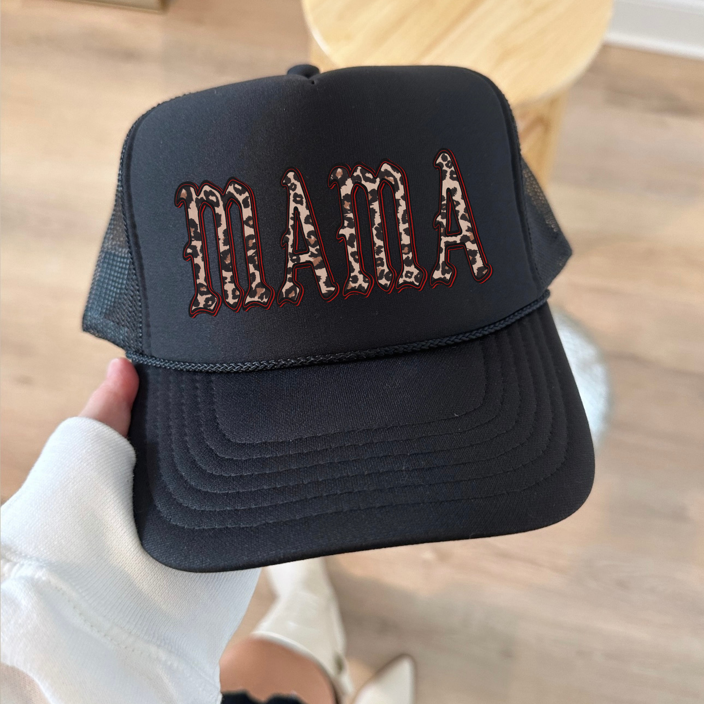MAMA Leopard Trucker Hat in black with leopard print lettering, structured front, curved brim, and mesh back