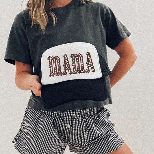 MAMA Leopard Trucker Hat with black mesh and white front panel, featuring bold leopard-print lettering
