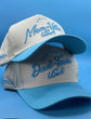 Mom-Ville Script Hat in beige with light blue embroidered script and pre-curved blue brim