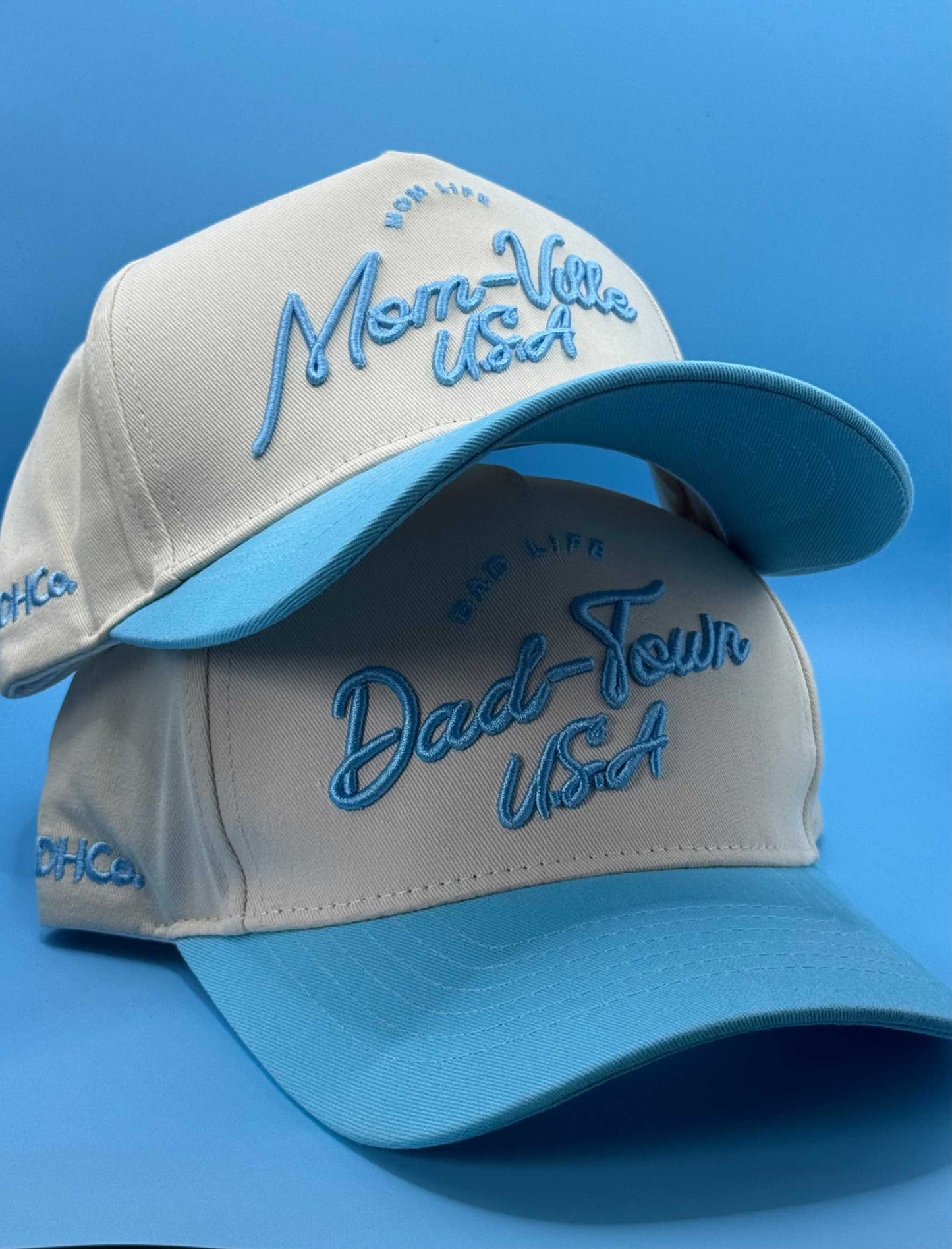 Mom-Ville Script Hat in beige with light blue embroidered script and pre-curved blue brim