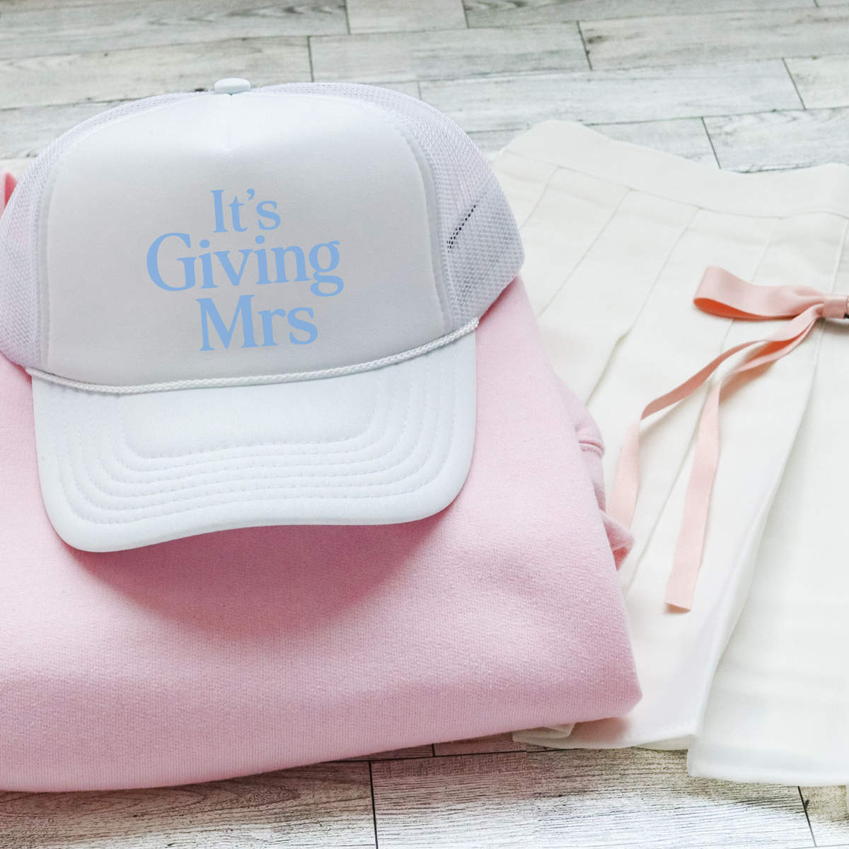 Mrs Trucker Hat in white foam-front mesh with light blue “It’s Giving Mrs” lettering and curved brim
