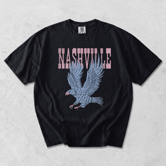 Nashville Eagle Graphic Tee in black cotton with distressed pink lettering and a blue flying eagle graphic