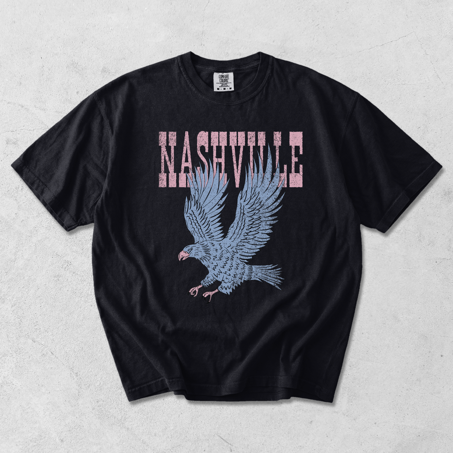 Nashville Eagle Graphic Tee in black cotton with distressed pink lettering and a blue flying eagle graphic