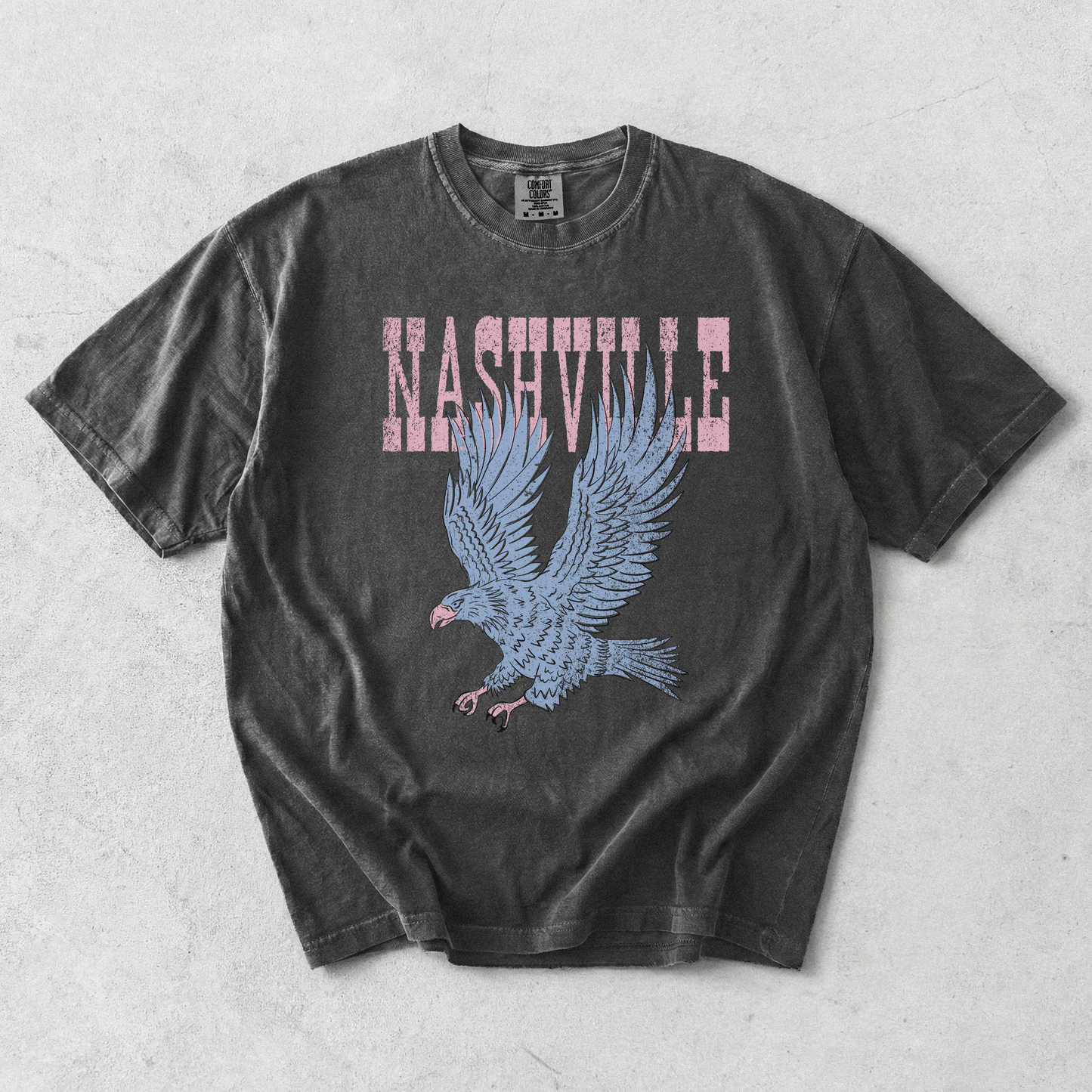 Nashville Eagle Graphic Tee in black cotton with distressed pink lettering and a blue flying eagle graphic