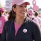 Pink Awareness Ribbon Pin on a white round button worn on a black jacket, symbolizing breast cancer support