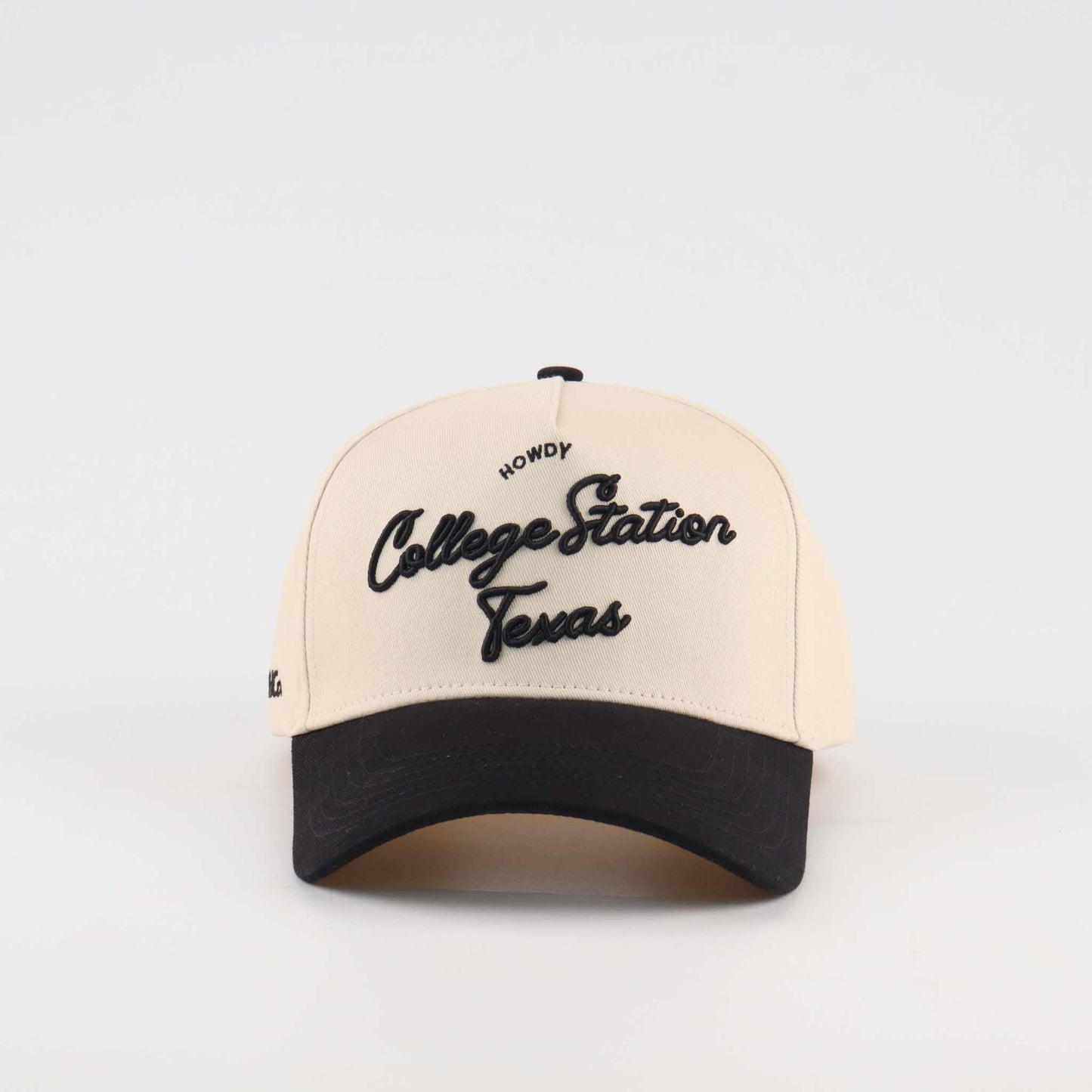 Pre-curved Trucker hat in beige and black with College Station Texas script lettering and curved brim