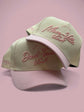 Pre-curved Trucker hat in beige with light pink brim and embroidered Mom-Ville and Dad script