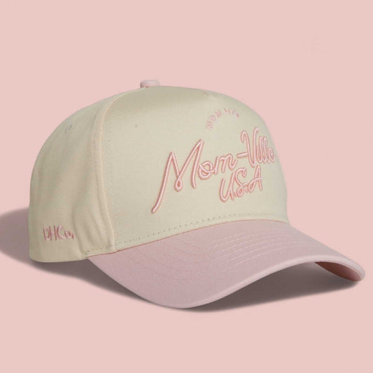 Pre-curved Trucker hat in beige and light pink with embroidered Mom-Ville script and curved brim