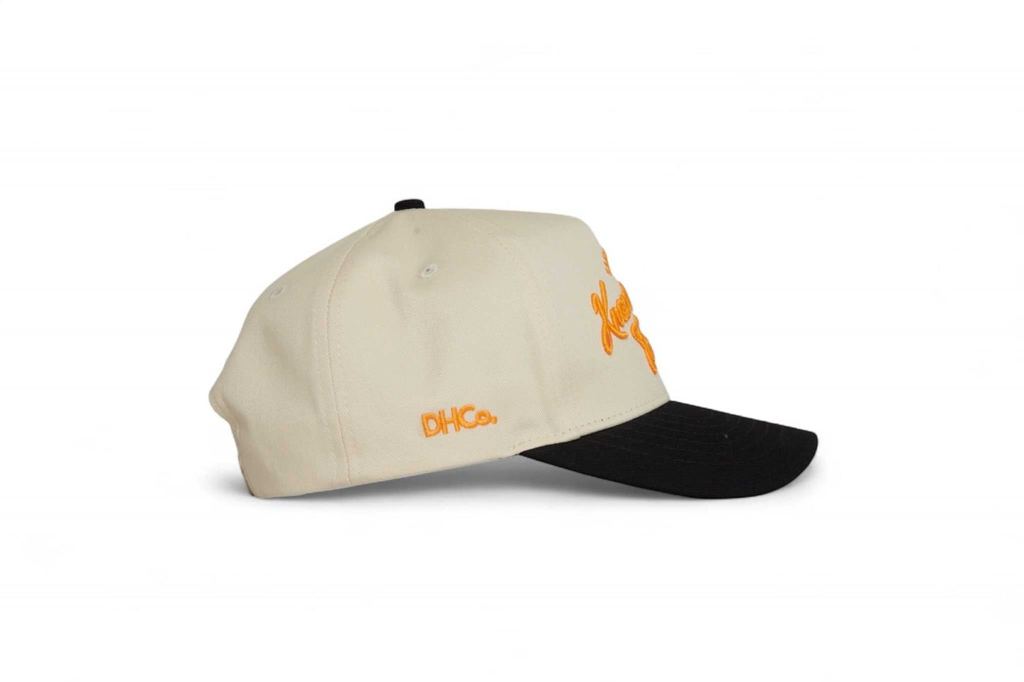 Pre-curved Trucker hat in cream with a black brim, orange Knoxville script and DHCo embroidery