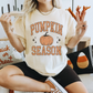Pumpkin Season Graphic Tee in cream cotton, featuring distressed orange lettering and a vintage pumpkin graphic with stars