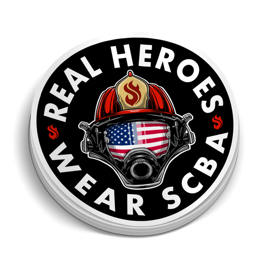 Real Heros Wear SCBA round black sticker featuring a firefighter helmet, gas mask, and American flag design