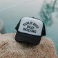 Really Busy Dilly Dallying Trucker Hat with white foam front, black mesh backing, curved brim, and bold statement text