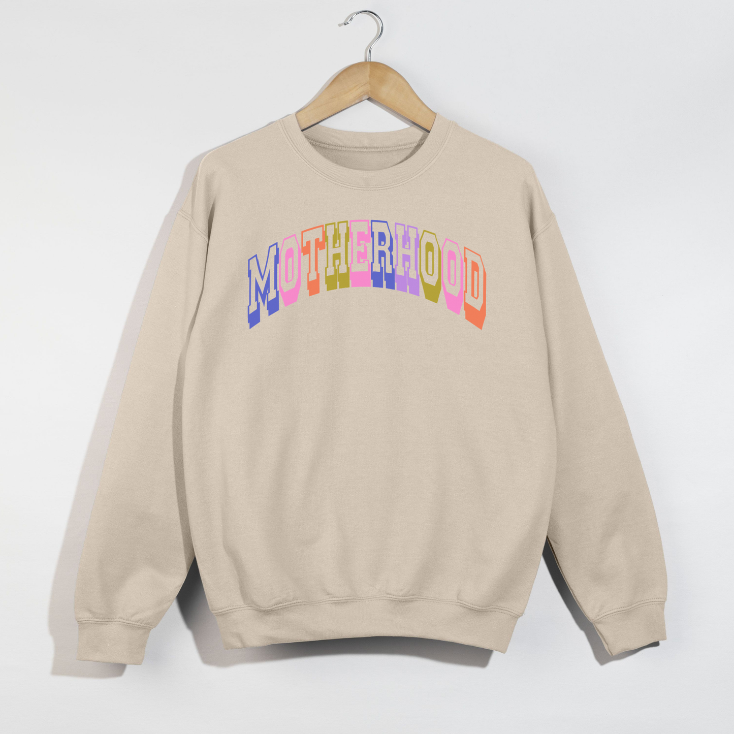Retro Motherhood Sweatshirt in sand fleece with colorful arched collegiate lettering and ribbed crewneck cuffs