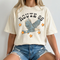 Graphic tee in ivory cotton with a distressed Route 66 eagle graphic, blue soaring eagle and orange stars