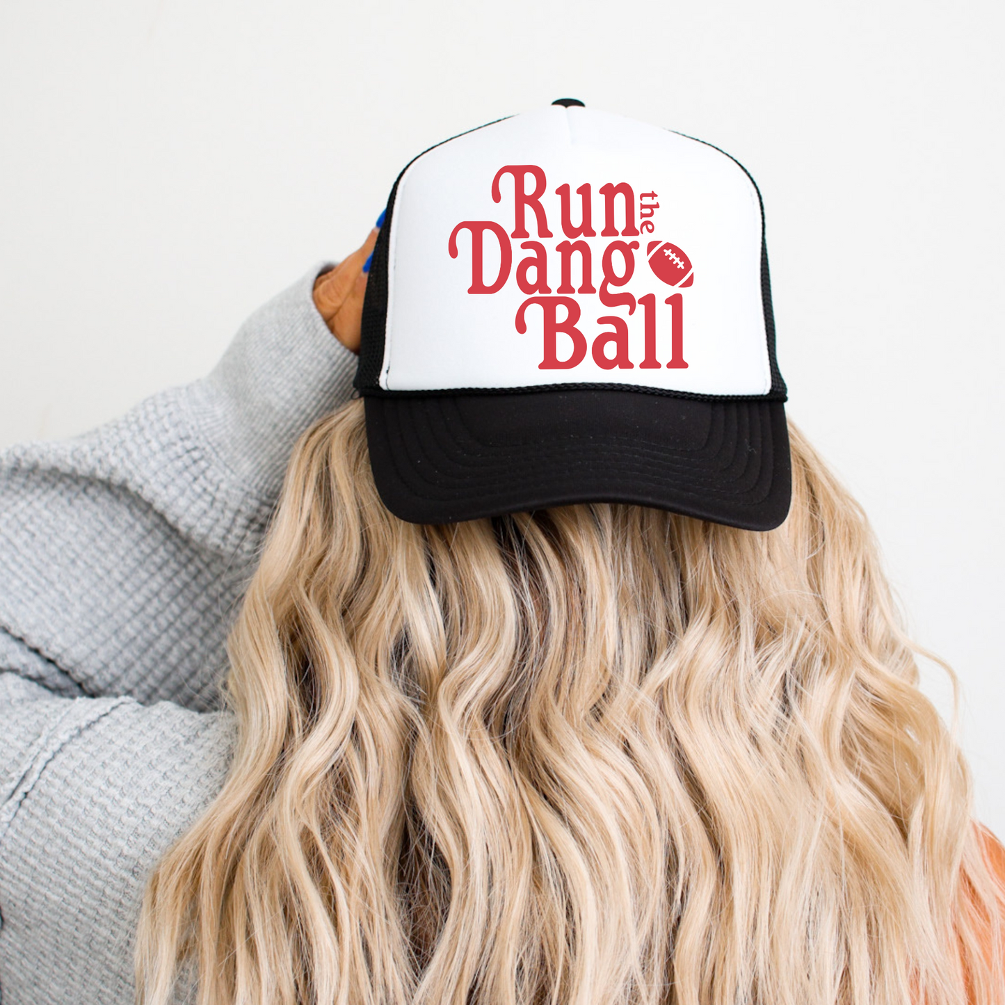 Run The Dang Ball trucker hat in black and white with red football graphic and adjustable mesh back