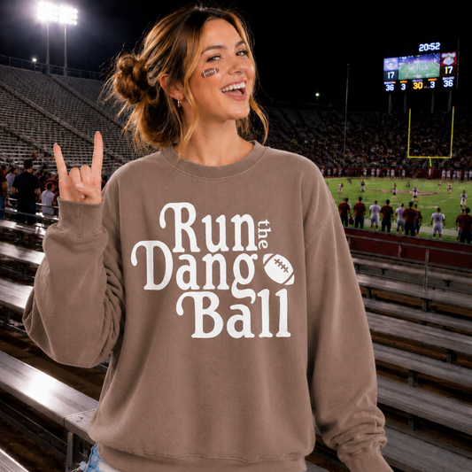Football sweatshirt in brown pigment-dyed cotton blend with cream Run the Dang Ball graphic and football icon.