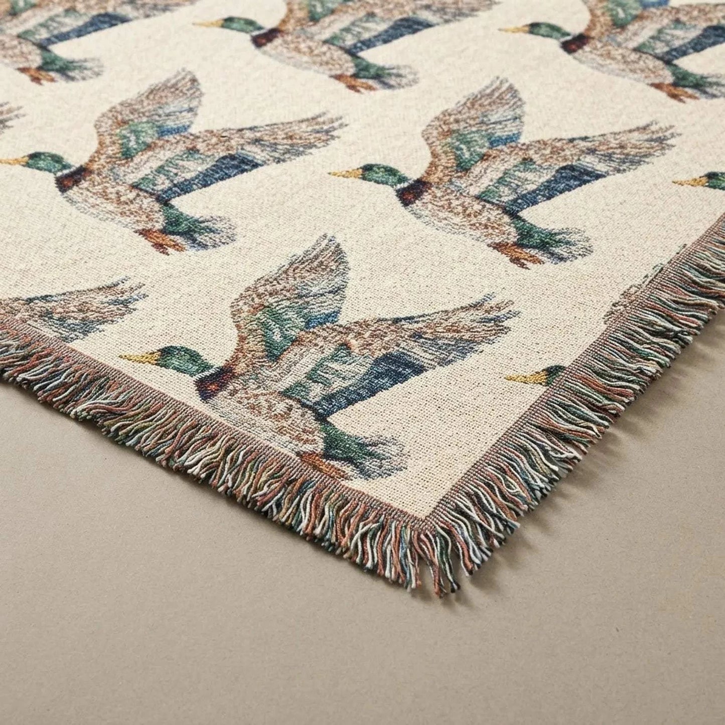Rustic Cabin Throw featuring a woven beige cotton fabric with flying mallard duck pattern and multicolor fringed edges