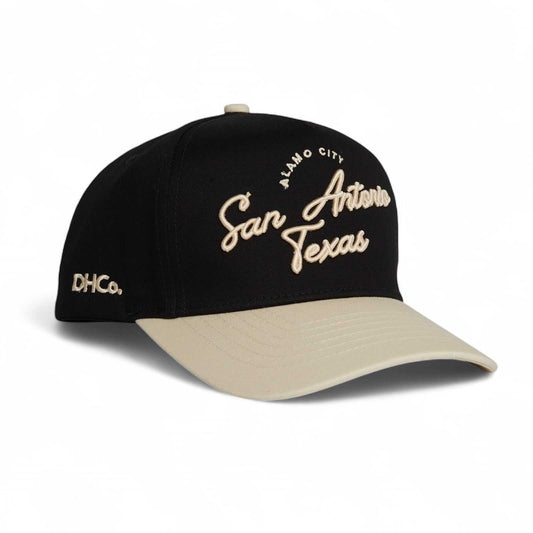 San Antonio Script Hat in black and beige cotton, featuring embroidered Alamo City, San Antonio Texas script and curved brim