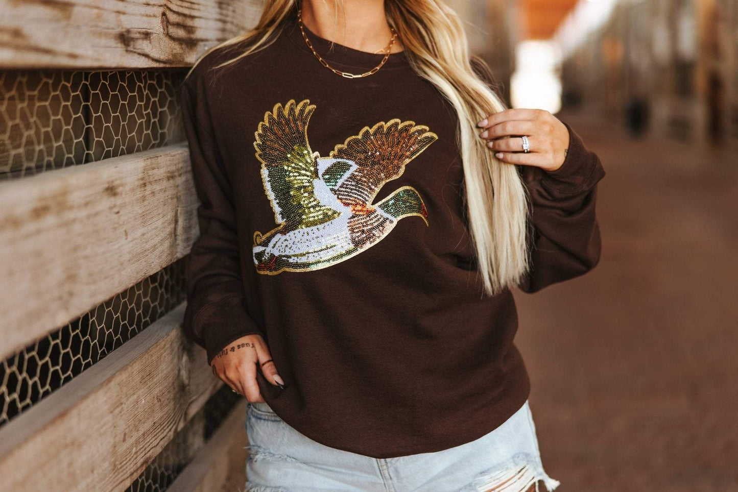 Unisex sweatshirt with shimmering sequin mallard duck patch on 50/50 cotton-poly blend