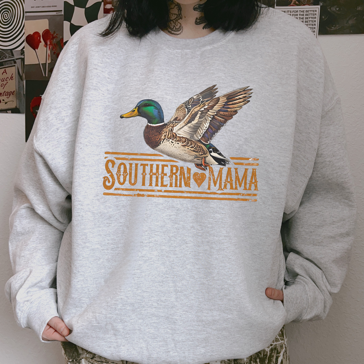 Southern Mama Duck light gray crewneck sweatshirt with a colorful flying mallard graphic and vintage orange lettering