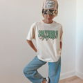 Southern Mama Tee white cotton T-shirt with green collegiate lettering and illustrated flying mallard graphic
