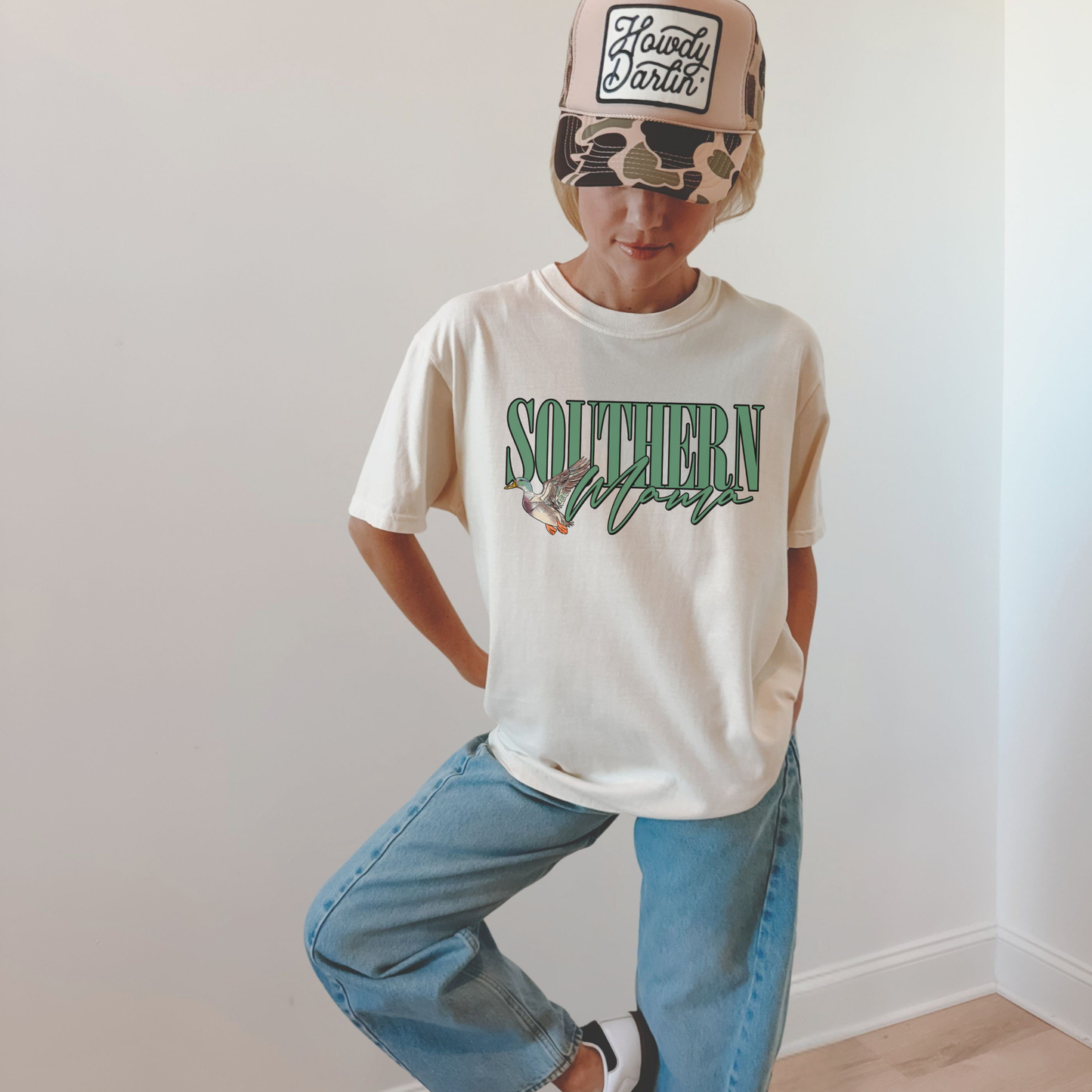Southern Mama Tee white cotton T-shirt with green collegiate lettering and illustrated flying mallard graphic